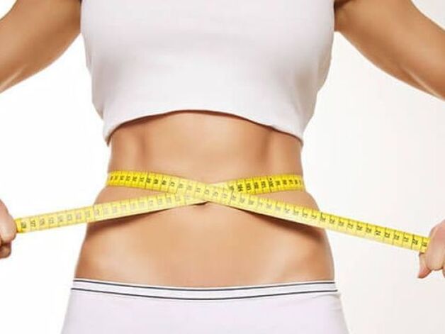 Middle of the waist with a centimeter ribbon